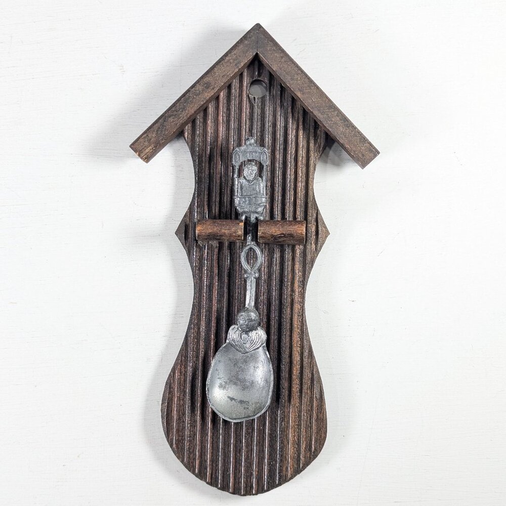 Vintage medieval-looking pewter spoon in wooden wall plaque display
